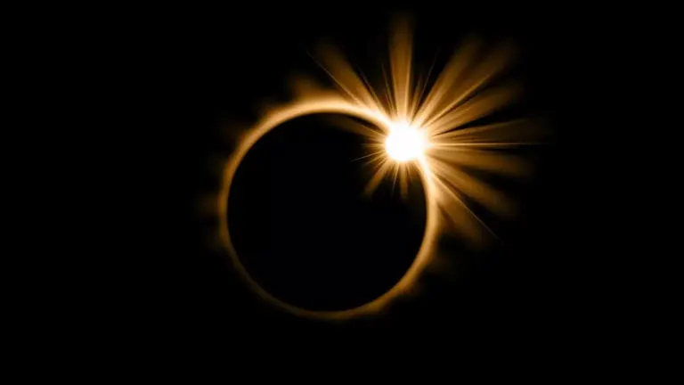 Partial solar eclipse with the moon partially covering the sun, showing bright rays and the sun's corona.