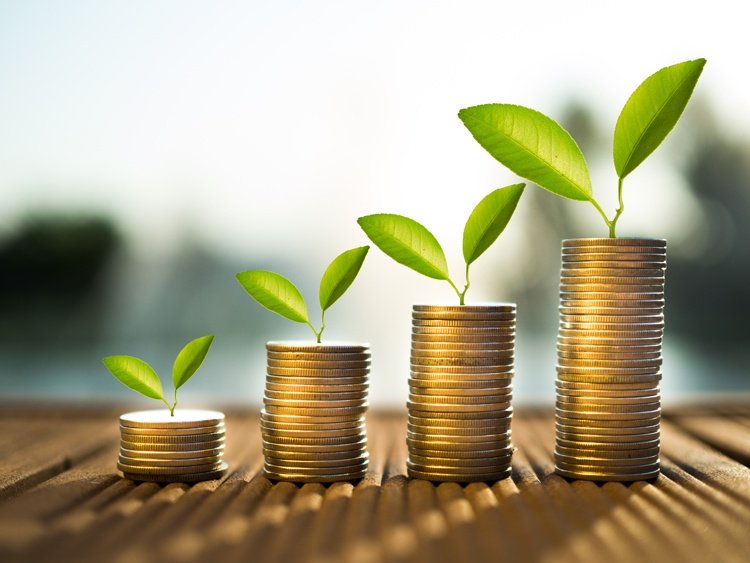Rockefeller Habits - Four stacks of coins in ascending order with small plants growing on top, symbolizing growth or investment.