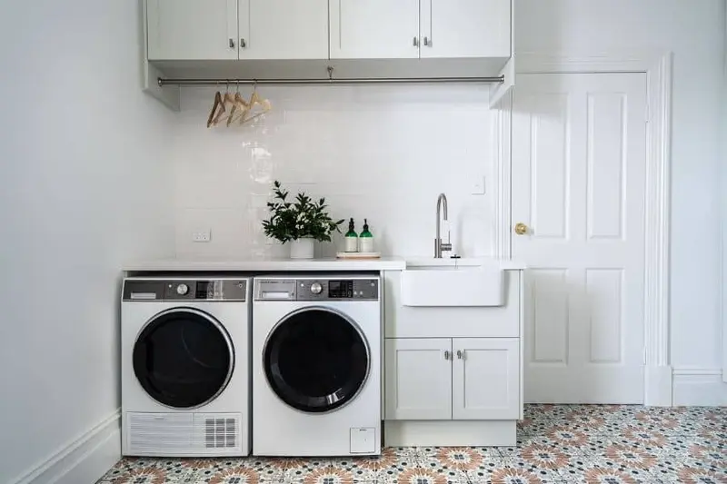 What is a deep sink: deep utility sink with washer and dryer in laundry room.