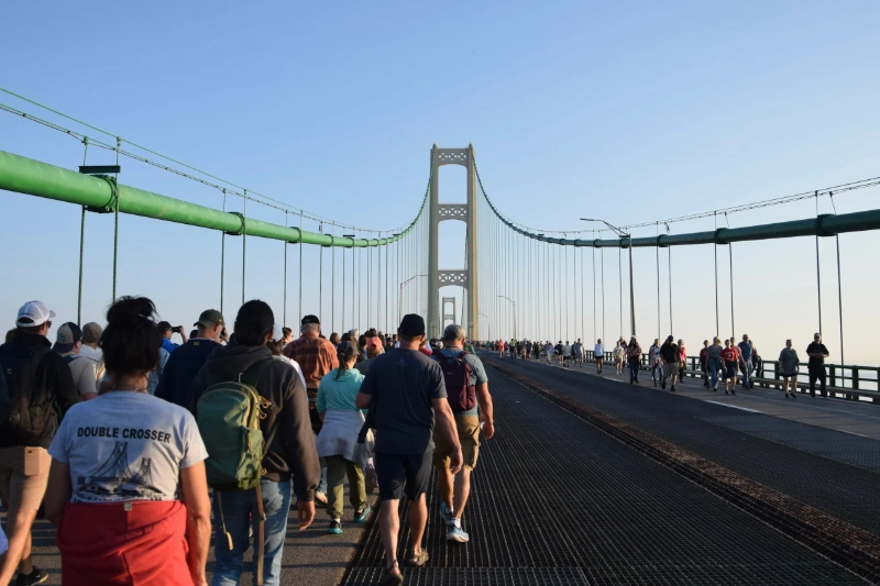 Crowd of people walking across the Mackinac Bridge on a sunny day, Image Credits: Mackinac Bridge Authority