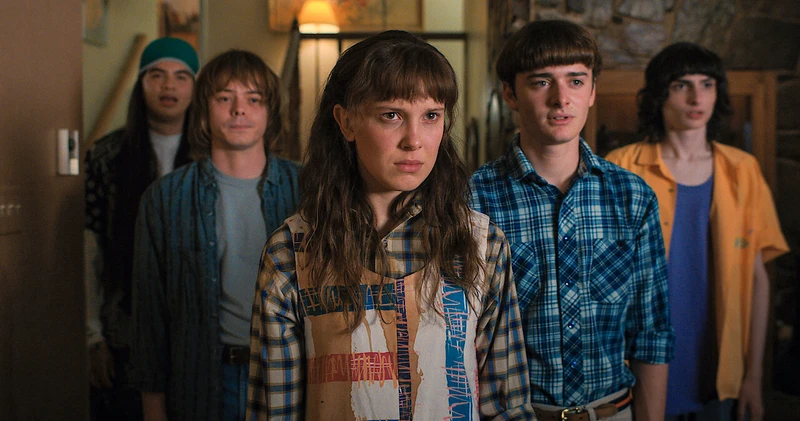 Stranger things cast: Argyle, Jonathan Byers, Eleven, Will Byers, Mike Wheeler in Season 4 scene.