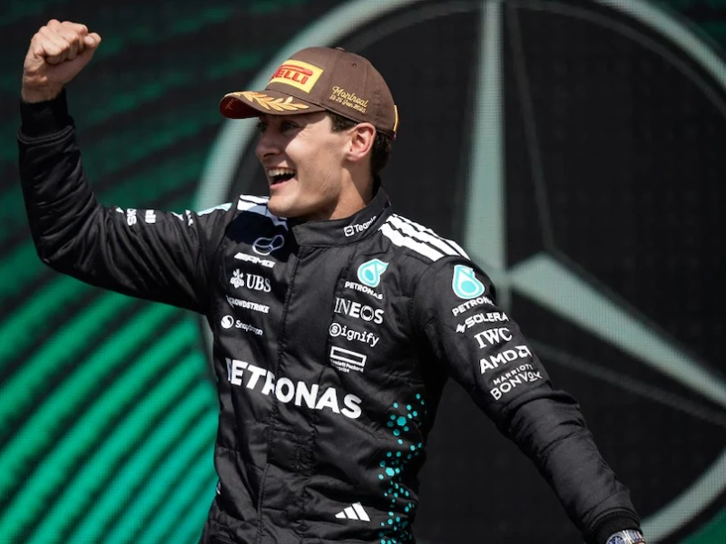 George Russell: celebrates Mercedes F1 victory, podium pose.