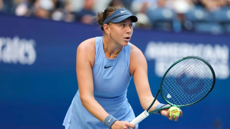 Anisimova prepares to serve in a tense US Open tennis match