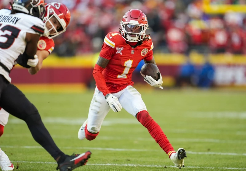 xavier worthy running with the football during an NFL game