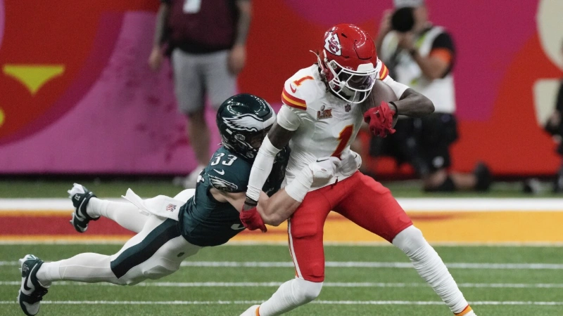 xavier worthy breaks a tackle during NFL game action