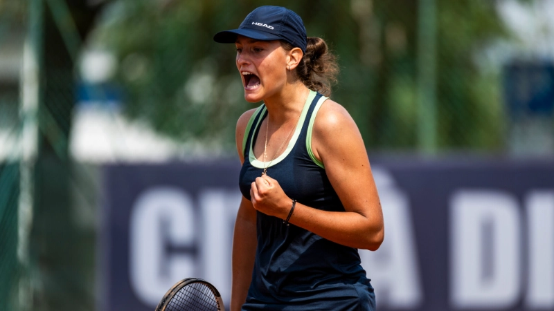 Elena Pridankina celebrates point at tennis match in navy dress and visor, Image Credits: (Jurij Kodrun / Stringer / Getty Images)