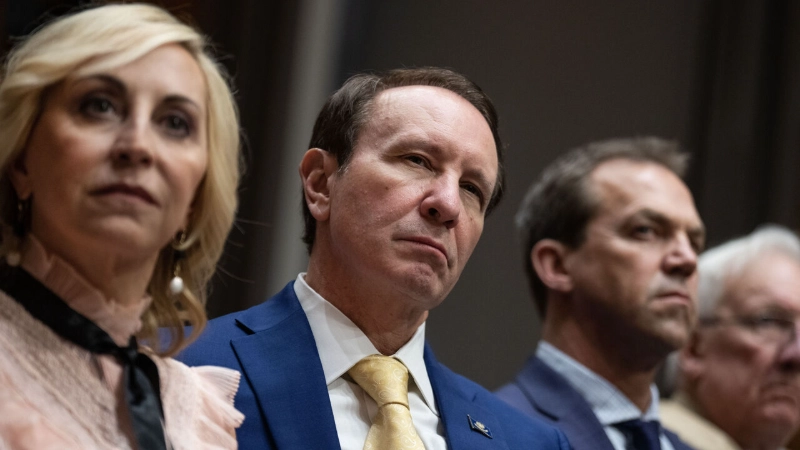 Jeff Landry in blue suit and yellow tie, seated among colleagues, Image Credits - (Tom Williams / CQ-Roll Call, Inc. / Getty)