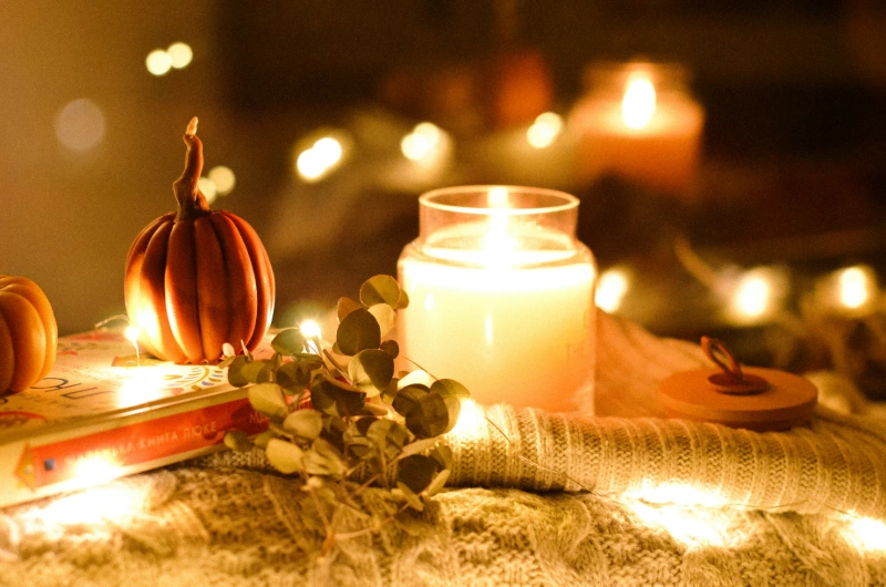 Thanksgiving pumpkin decor and candle lights, image credits: Anastasiia Romanska