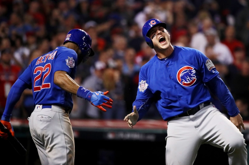 Two Chicago Cubs players celebrate with a high-five during Game 7 of the World Series, Image Credits: Ezra Shaw/Getty Images