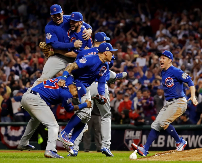 Chicago Cubs players leap and pile in celebration after winning Game 7 of the World Series, Image Credits: Matt Slocum/Associated Press