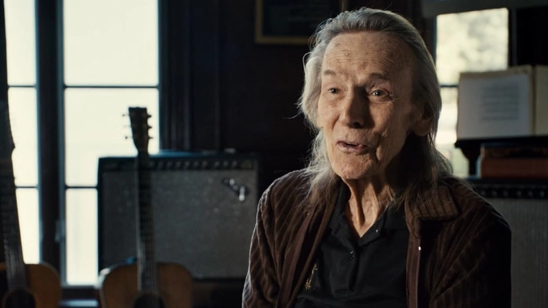 Gordon Lightfoot in a studio setting, surrounded by guitars and amps. Image Credits: Greenwich Entertainment