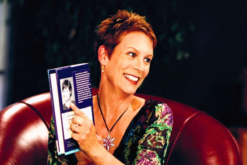 jamie lee curtis holding book on red chair, image credits: Walt Disney/Everett