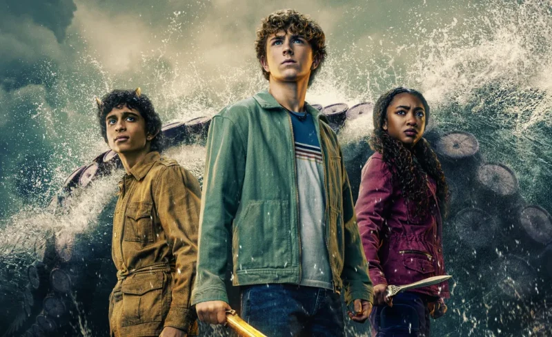 Percy Jackson, Annabeth, and Grover with swords, ready for battle in front of a giant sea monster in Disney+ Percy Jackson series.