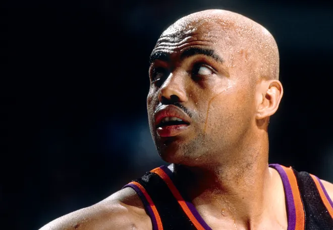 A basketball player in action wearing a jersey with black, purple, and orange colors. Credit: US PRESSWIRE related to Charles Barkley.
