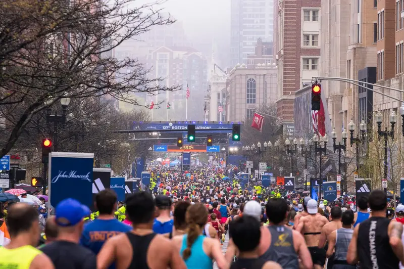 Crowd of runners nears Boston Marathon 2025 finish line.