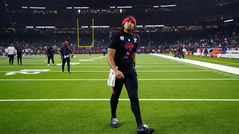C.J. Stroud walking on football field.