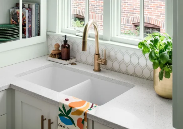 What is a deep sink: modern deep kitchen sink with gold faucet and countertop.