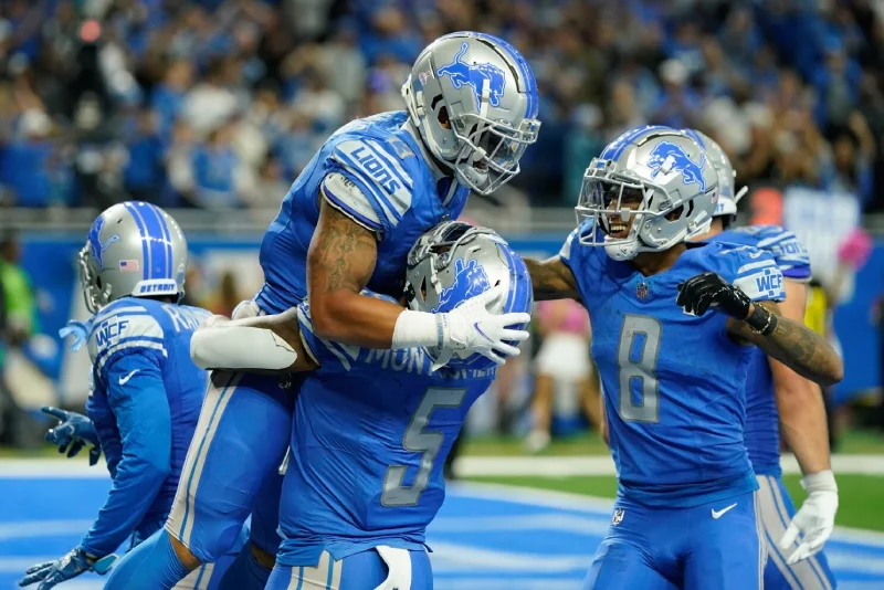 Lions Schedule 2025: Detroit Lions players celebrate touchdown in end zone during NFL game.