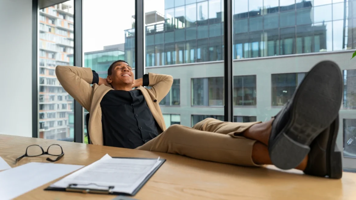 Rockefeller habits: successful businessman relaxing in modern office.