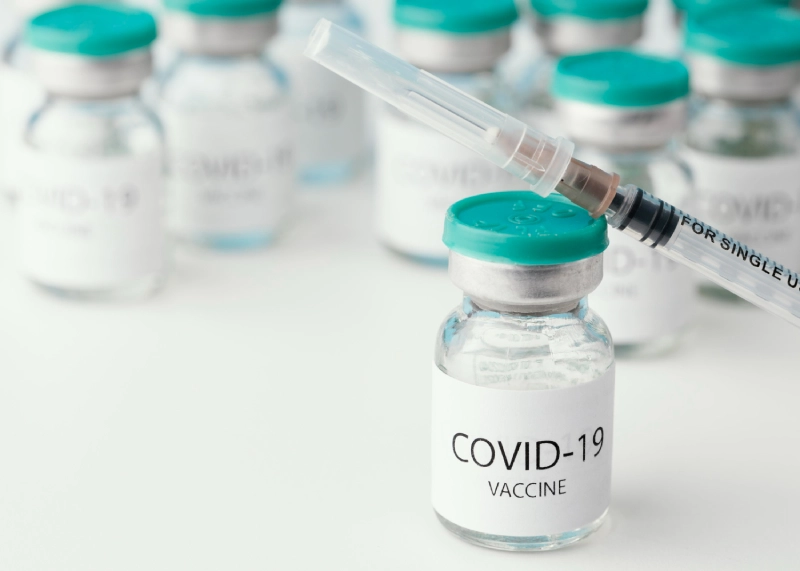 COVID vaccines: vial and syringe close-up.