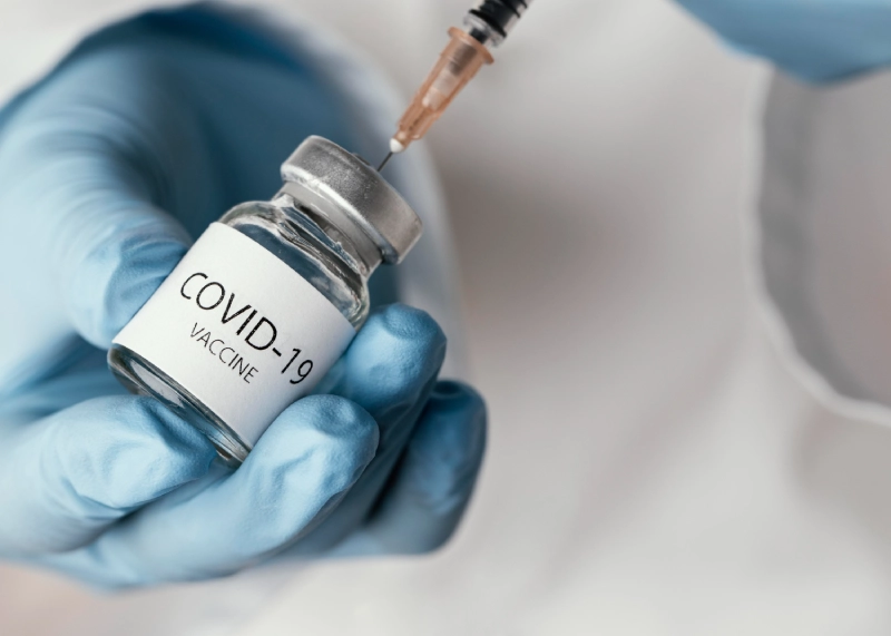 COVID vaccines: vial and syringe close-up.