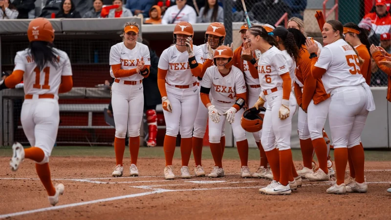 Texas softball roster: Longhorns players celebrate at home plate in white uniforms.