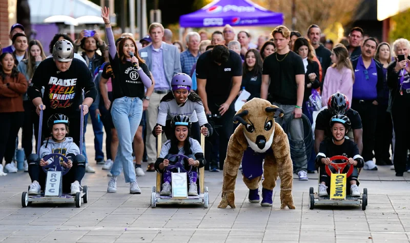 What is homecoming: GCU students and mascot Thunder in derby cart race at Homecoming.
