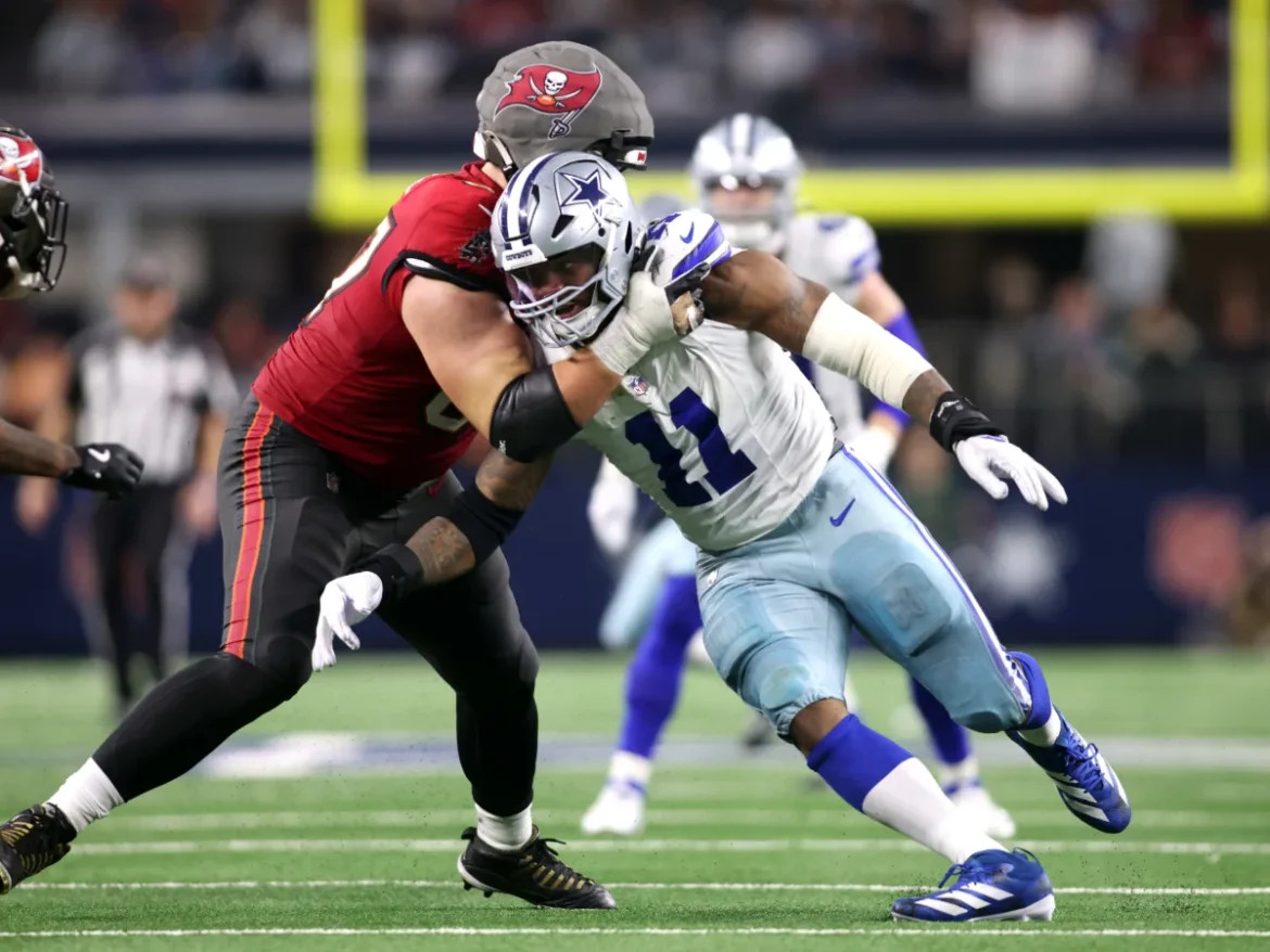 Micah Parsons: Dallas Cowboys #11 tackling Buccaneers in NFL game.
