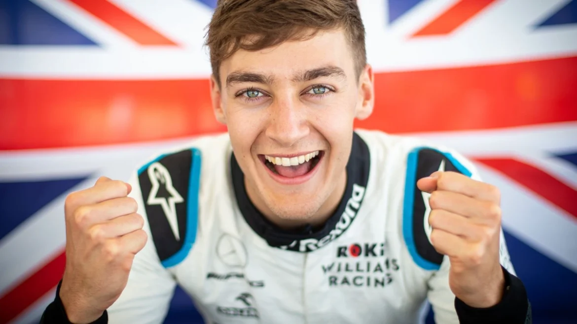 George Russell: British F1 driver celebrates with fists raised, UK flag.