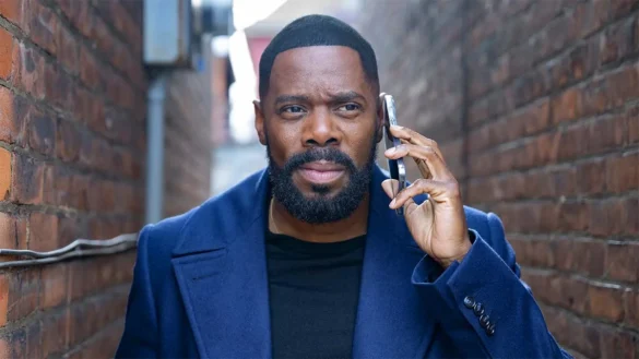 Colman Domingo talking on phone in blue coat