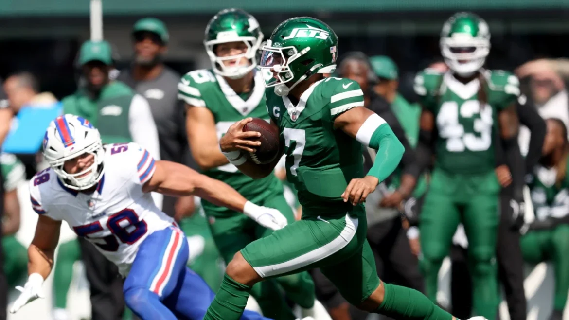 Justin Fields rushing for Jets against Bills defender during NFL game.
