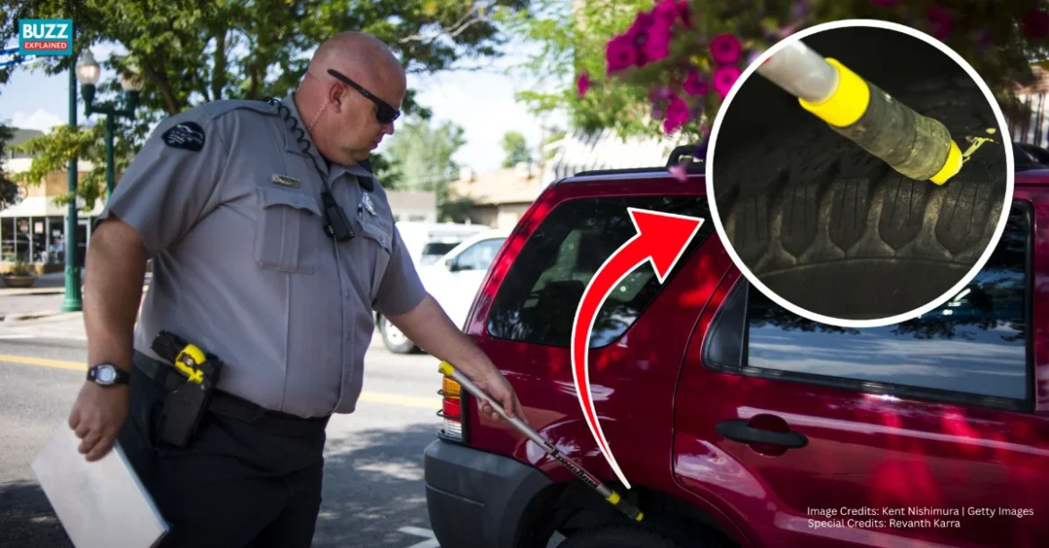 What does chalk on tires do - officer marking tire for parking enforcement, credits Kent Nishimura | Getty Images
