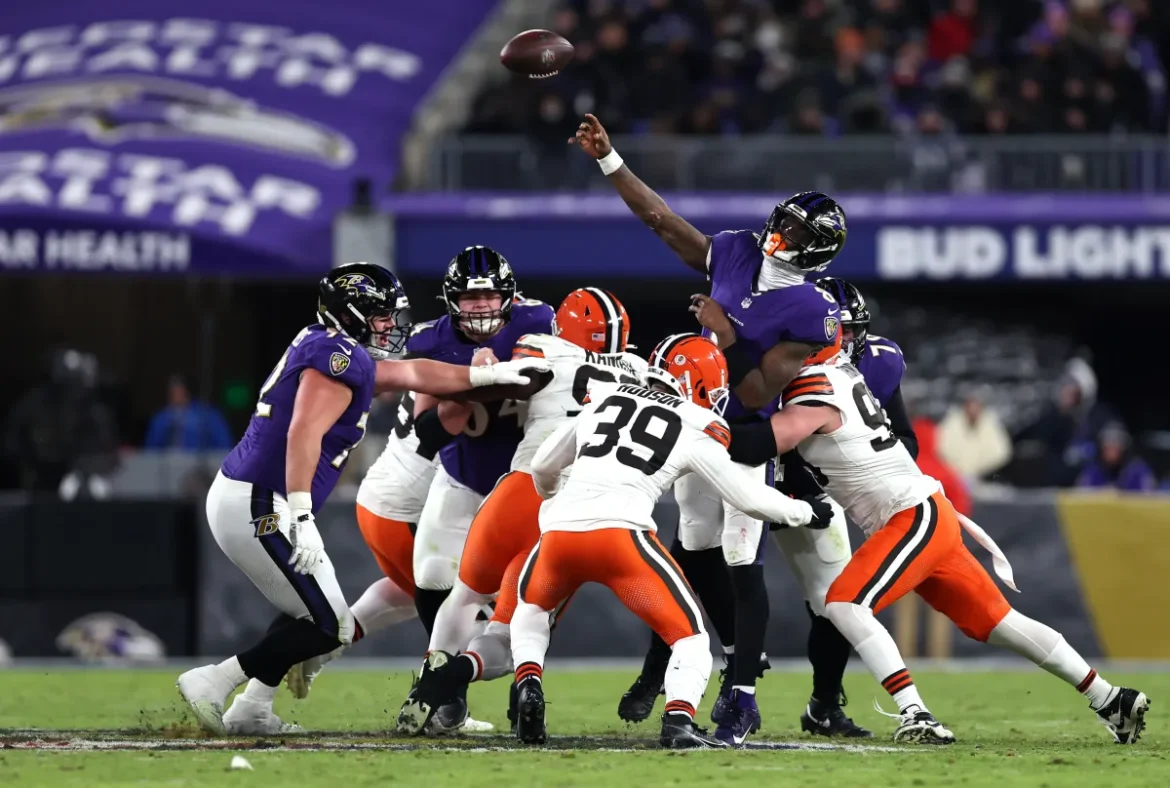 Lamar Jackson of Ravens passes the ball as Browns defenders close in, NFL Week 7, Nick Grace/Getty Images.