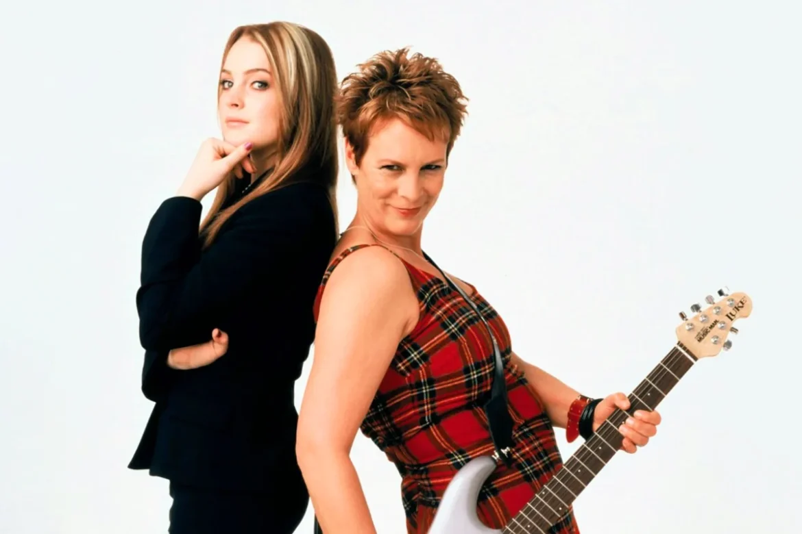 jamie lee curtis and co-star back to back, holding guitar, image credits: Walt Disney/Everett Collection