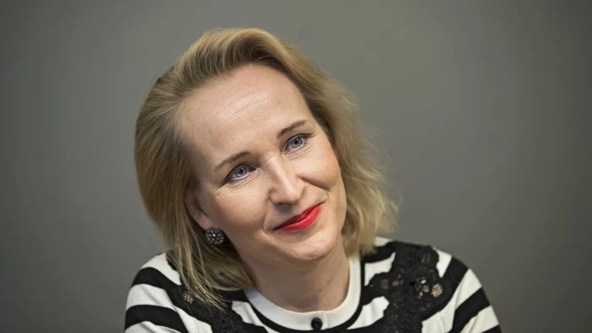 Minna Helle, Finnish labor market leader and negotiator, smiles in a striped shirt. Image Credits - Leif Weckström