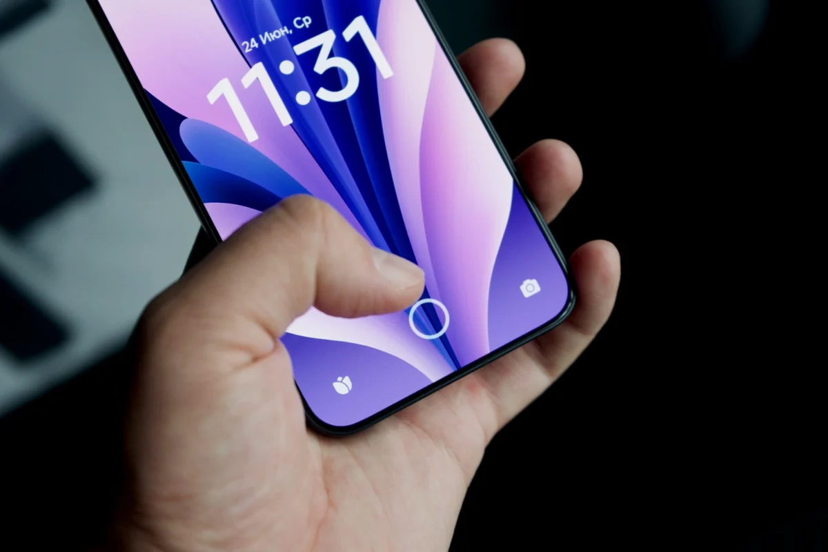 A person unlocking a smartphone with a fingerprint