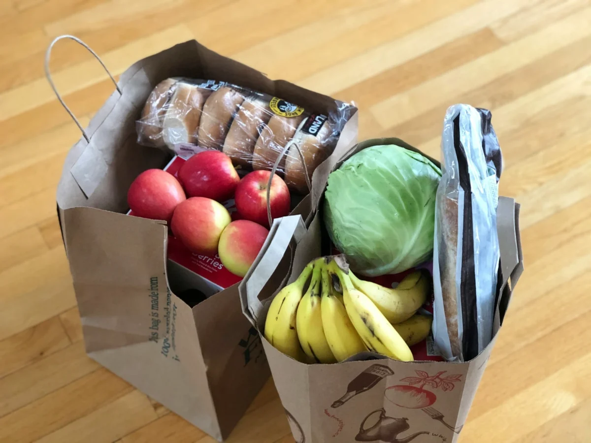 A shopping basket filled with everyday grocery items