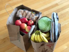 A shopping basket filled with everyday grocery items