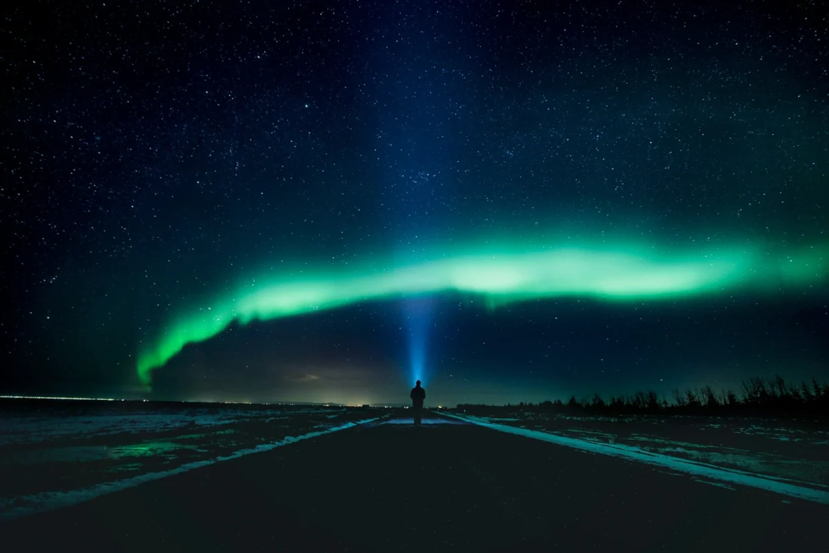 Green northern lights glowing across the night sky